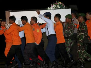 Members of the National Search And Rescue Agency carry a coffin containing the body of one of the victims on board the ill-fated AirAsia Flight 8501 to transfer to Surabaya at the airport. AP 