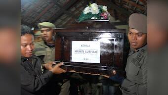 Relatives hold first AirAsia funeral as bad weather hampers search for flight  QZ8501
