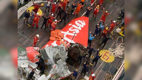 Divers hunt for bodies in crashed AirAsia jet's fuselage