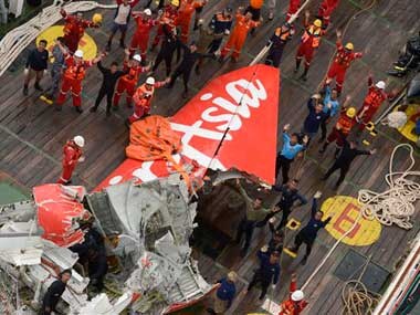 Divers hunt for bodies in crashed AirAsia jet's fuselage