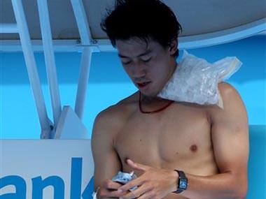 Kei Nishikori of Japan rests between games with an ice pack on his shoulder. AP