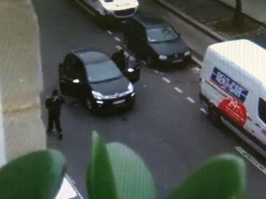 In this image made from amateur video recorded on Wednesday, Jan. 7, 2015 by Jordi Mir, masked gunman get into a car moments after shooting a police officer outside the offices of French satirical newspaper Charlie Hebdo in Paris. AP 