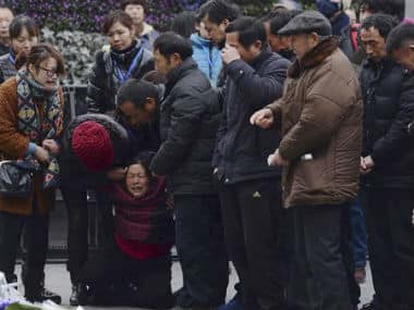 A woman, third from left, grieves as she is comforted by other relatives of a New Year's Eve stampede victim at the site of the tragic accident in Shanghai, China. AP 