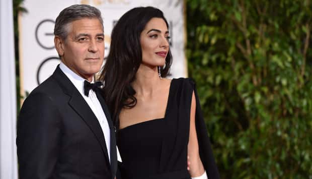 George Clooney, left, and Amal Clooney arrive at the 72nd annual Golden Globe Awards. AP