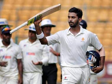 Karnataka's K L Rahul raises his bat after scoring his hundred runs against Uttar Pradesh during Ranji trophy match. PTI