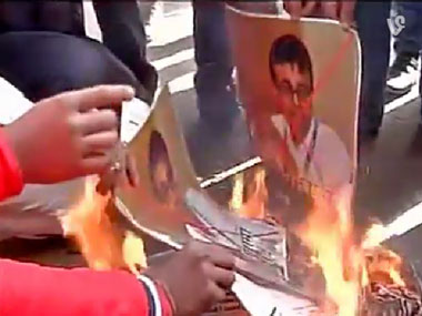 Pakistan terror boat: Protesters burn photos of journalist Praveen Swami in Delhi Pakistan terror boat: Protesters burn photos of journalist Praveen Swami in Delhi