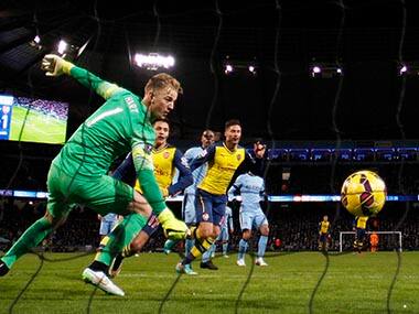 Manchester City goalkeeper Joe Hart watches as he fails to stop Arsenal's Olivier Giroud (C) scoring a goal. Reuters