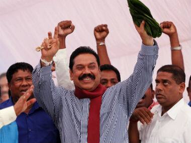 Sri Lankan President Mahinda Rajapaksa greets supporters during his election campaign rally in Colombo, Sri Lanka. AP