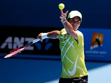Roger Federer of Switzerland practices serving at the Australian Open. AP