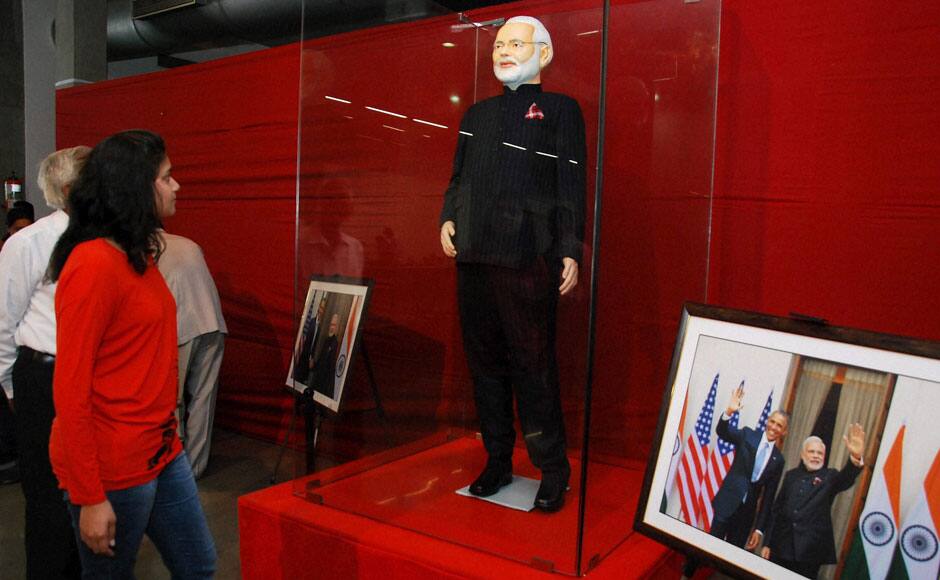 Surat: A visitor looks at Prime Minister Narendra Modi’s controversial pinstripe monogrammed bandhgala suit during its auction in Surat on Wednesday. The Prime Minister wore this suit during US President Barack Obama’s visit to India last month. PTI 