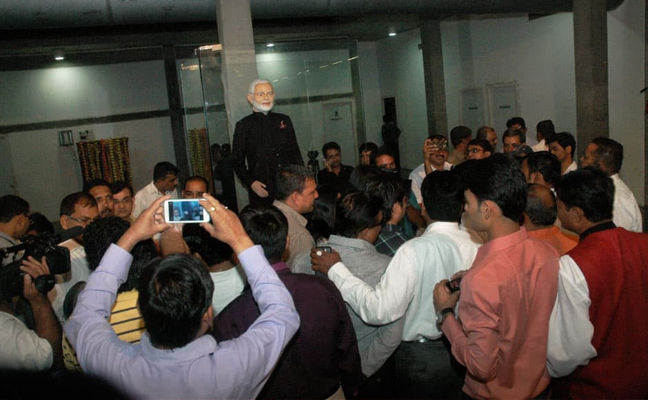 Surat: Visitors click pictures of Prime Minister Narendra Modi’s controversial pinstripe monogrammed bandhgala suit during its auction in Surat on Wednesday. The Prime Minister wore this suit during US President Barack Obama’s visit to India last month. PTI