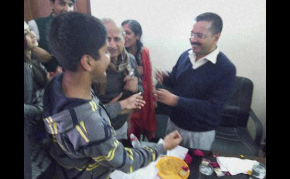 Kaushambi : AAP convener Arvind Kejriwal celebrates with his family members after the early counting trends showed the party’s win in the Assembly polls, at his residence in Kaushambi on Tuesday. PTI