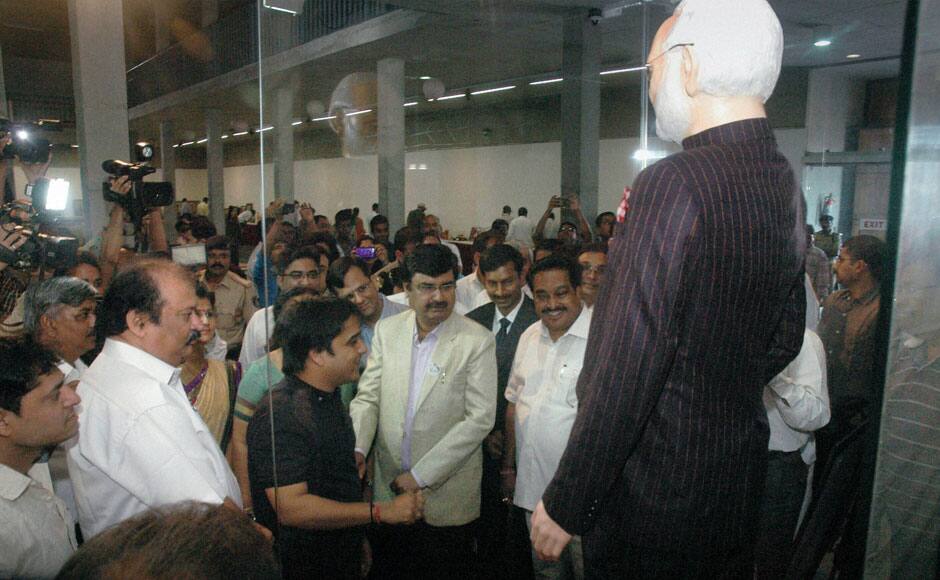 Surat: People watch Prime Minister Narendra Modi's pinstripe monogrammed bandhgala suit that he wore during US President Barack Obama's visit, went for an auction, in Surat on Wednesday. PTI