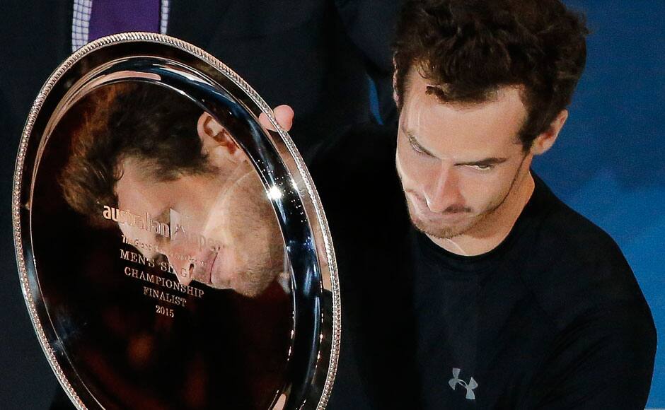 Andy Murray of Britain is reflected in his runner-up trophy during the prize-giving ceremony after losing to Novak Djokovic of Serbia in their men's singles final match at the Australian Open 2015 tennis tournament in Melbourne February 1, 2015. REUTERS