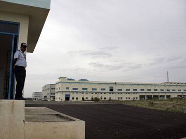 A security guard stands at the entrance of a factory operated by Taiwan-based IT giant Foxconn at Sriperumpudur. AFP