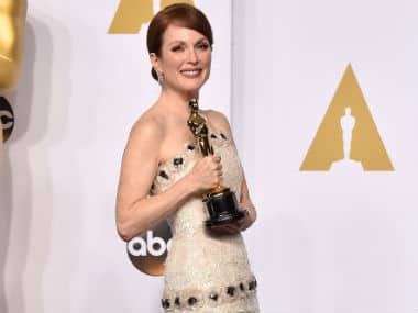 Julianne Moore poses in the press room with the award for best actress in a leading role for her work on “Still Alice