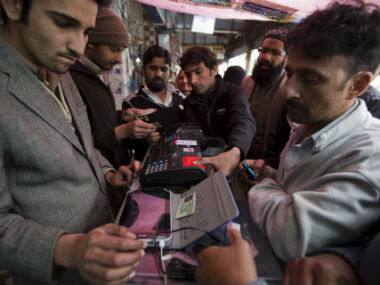 People get their cell phone SIM cards verified in Islamabad, Pakistan. AP 