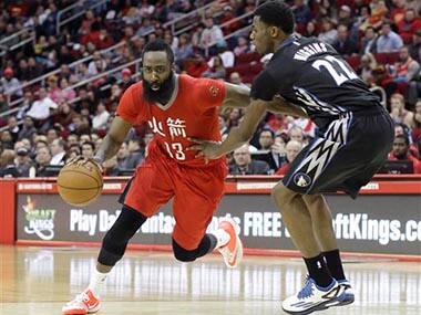 Houston Rockets' James Harden (13) pushes past Minnesota Timberwolves' Andrew Wiggins (22) in the second half of an NBA basketball game . AP