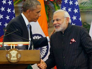 Narendra Modi greets Barack Obama in his pinstriped suit. Reuters