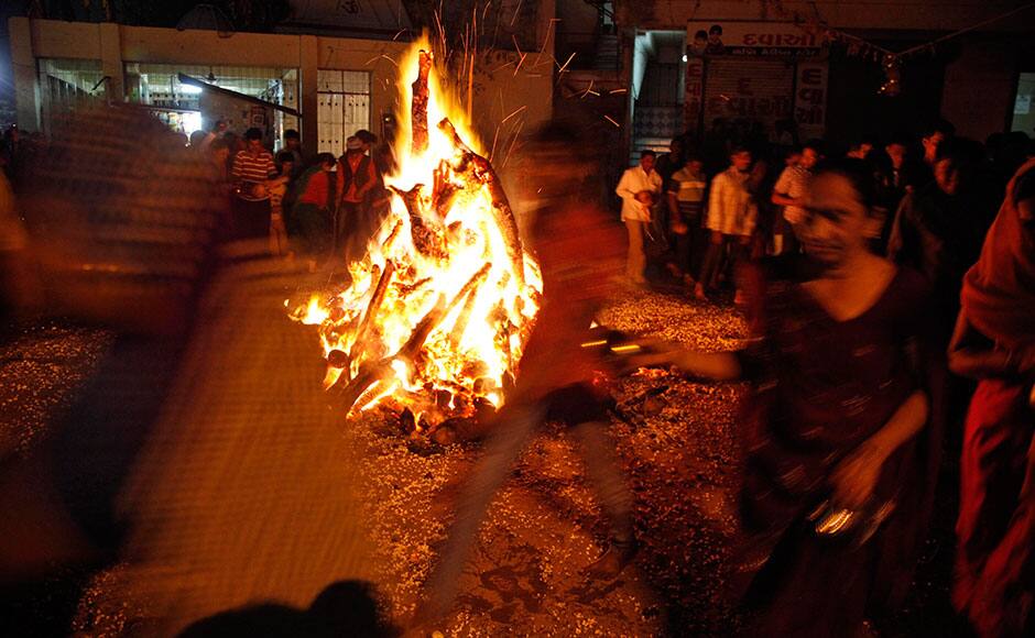 Indians perform rituals around a bonfire during Holi festival celebrations in Ahmadabad, India, Thursday, March 5, 2015. People across the country will celebrate Holi on March 6. AP 