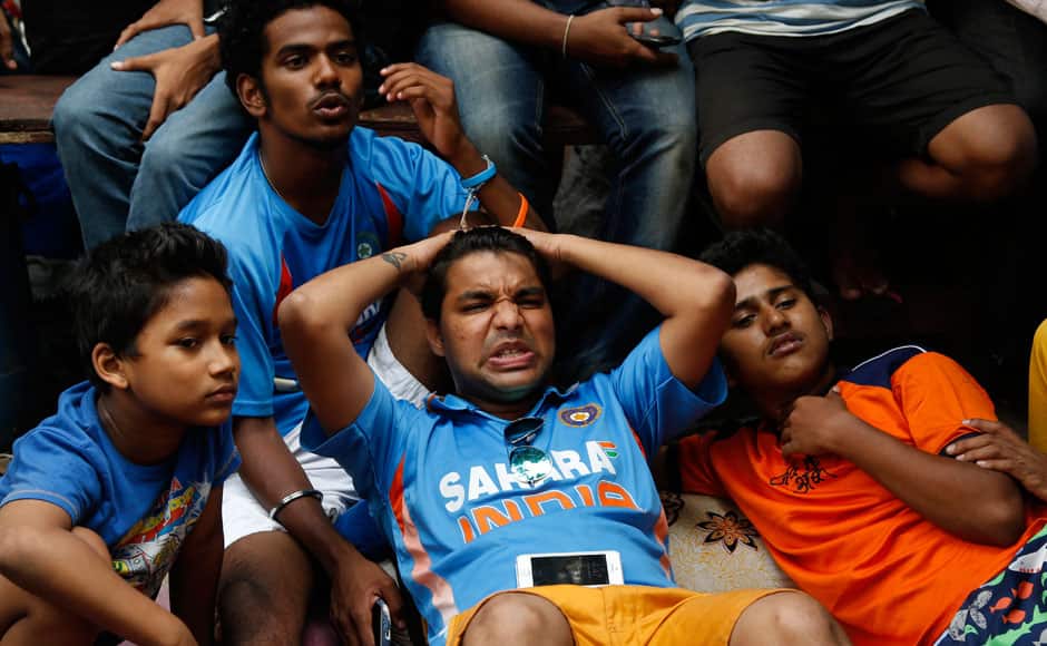 Indian cricket fans react as they watch on television the ICC Cricket World Cup semifinal match between India and Australia in Mumbai, India, Thursday, March 26, 2015. Australia ended 2011 champion India's unbeaten run at the World Cup with a 95-run victory Thursday. AP