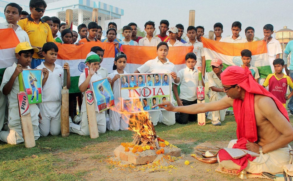 Young cricket fans perform yajna for the Indian Cricket team's victory ahead of their Semi final clash with Australia of ICC Cricket World Cup-2015, at Balurghat in South Dinajpur district of West Bengal on Wednesday. PTI