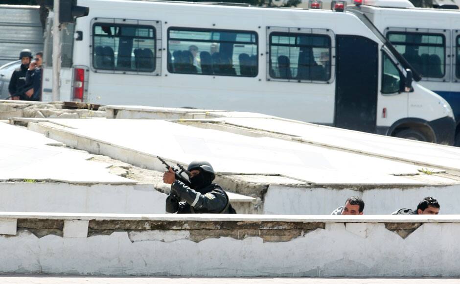 Police officers are seen outside parliament in Tunis March 18, 2015. Gunmen attacked Tunisia's national museum near its parliament on Wednesday, killing at least seven tourists and taking others hostage inside the building, the government said. REUTERS