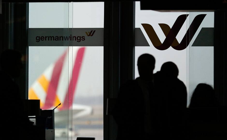 Passengers are silhouetted against a window at the Germanwings check-in desk at Dusseldorf airport March 24, 2015. No one survived when an Airbus A320 passenger plane operated by Lufthansa's budget subsidiary Germanwings crashed in southern France while flying from Barcelona to Dusseldorf on Tuesday and it is likely to take days to recover the bodies of those on board due to difficult terrain, French police at the crash site said. REUTERS
