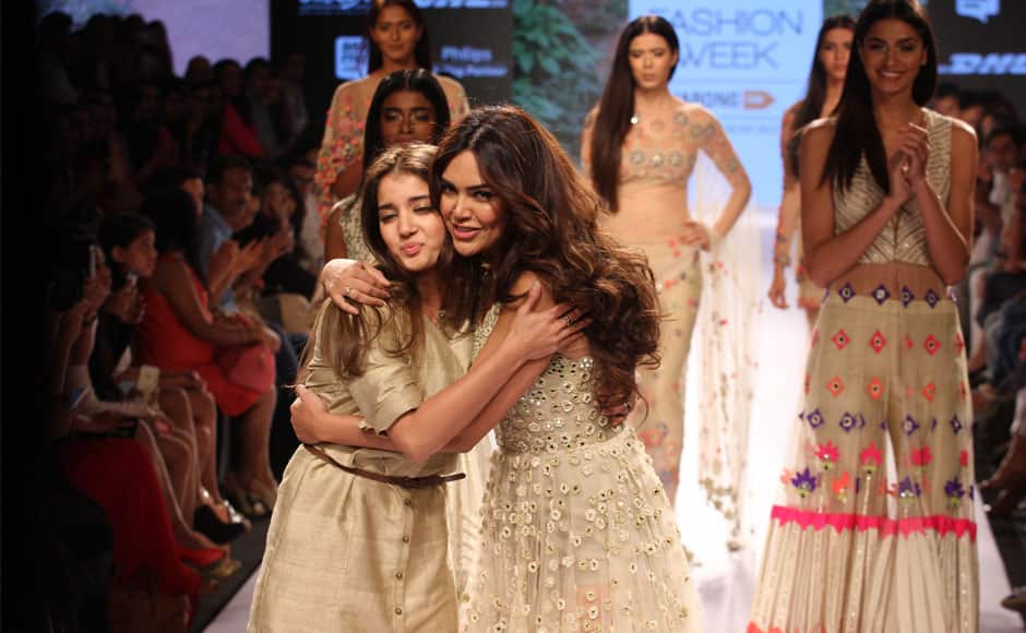 Bollywood actress Isha Gupta (R) hugs designer Arpita Mehta (L), during the Lakme Fashion Week Summer/Resort 2015, in Mumbai, India on March 21, 2015. Solaris Images