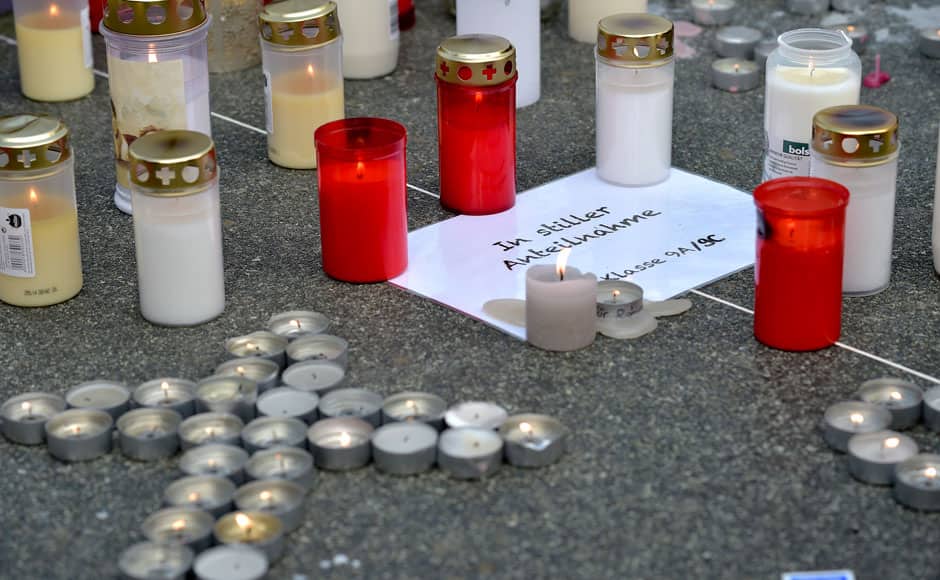 Lit candles are placed outside the Josef-Koenig-Gymnasium high school in Haltern am See, March, 24, 2015. Students and teachers at a small-town German high school broke out in tears when they realised that 16 classmates and two teachers were on board an ill-fated Germanwings airplane that crashed in France on Tuesday on a flight home to Duesseldorf. The text reads: 'In silent sympathy.' REUTERS