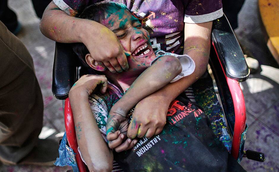 Children covered in coloured powder play during celebrations of Holi, also known as the festival of colours, at the Society for the Education of the Crippled in Mumbai March 4, 2015. The traditional event heralds the beginning of spring and is celebrated all over India. REUTERS
