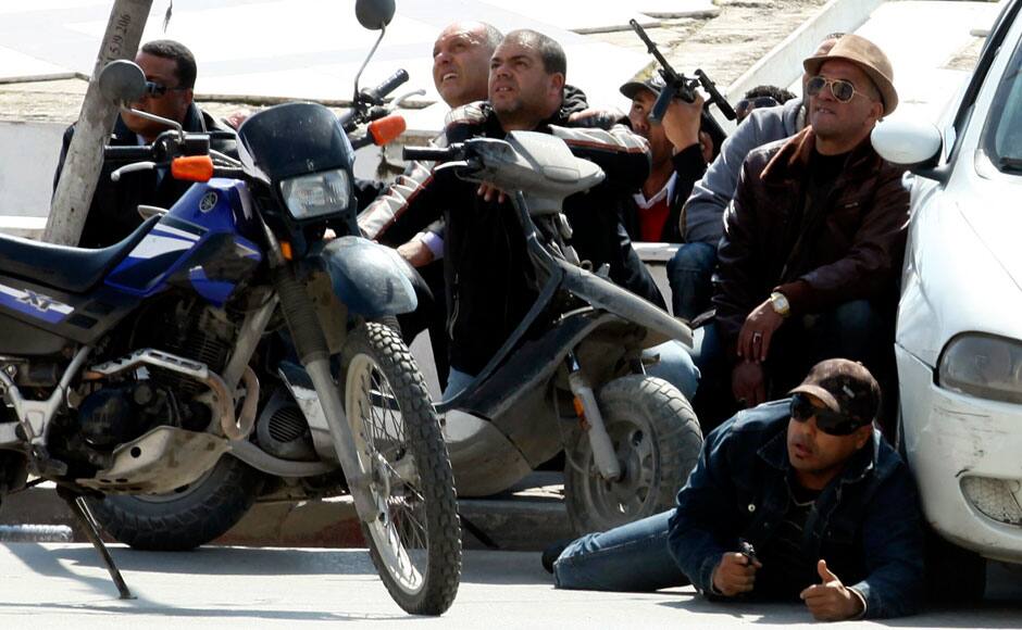 Police officers are seen on the pavement outside parliament in Tunis March 18, 2015. Gunmen attacked Tunisia's national museum near its parliament on Wednesday, killing at least seven tourists and taking others hostage inside the building, the government said. REUTERS