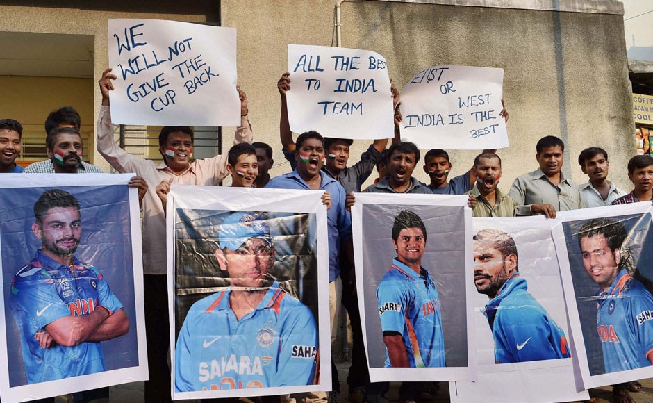 Cricket fans hold the poster of Indian Cricket players wishing them for their World Cup semi final clash against Australia to be held in Sydney, in Bengaluru on Wednesday. PTI