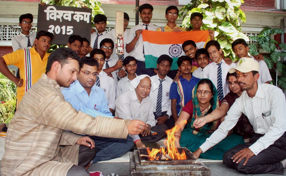 Teachers and students perform 'yagya' for the Indian Cricket team's victory ahead of their semi final match against Australia, in Varanasi on Wednesday. PTI