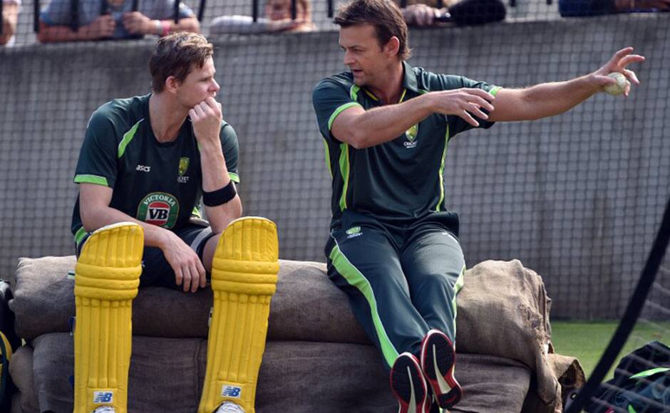 Former Australian wickertkeeper Adam Gilchrist (R) talks to batsman Steve Smith during a practice session. Some last moment tips it seems. AFP