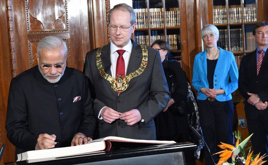 Hannover: Prime Minister Narendra Modi with mayor of   Hannovea signs golden book during his visit to City Hall in Hannover, Germany on Sunday.  PTI 