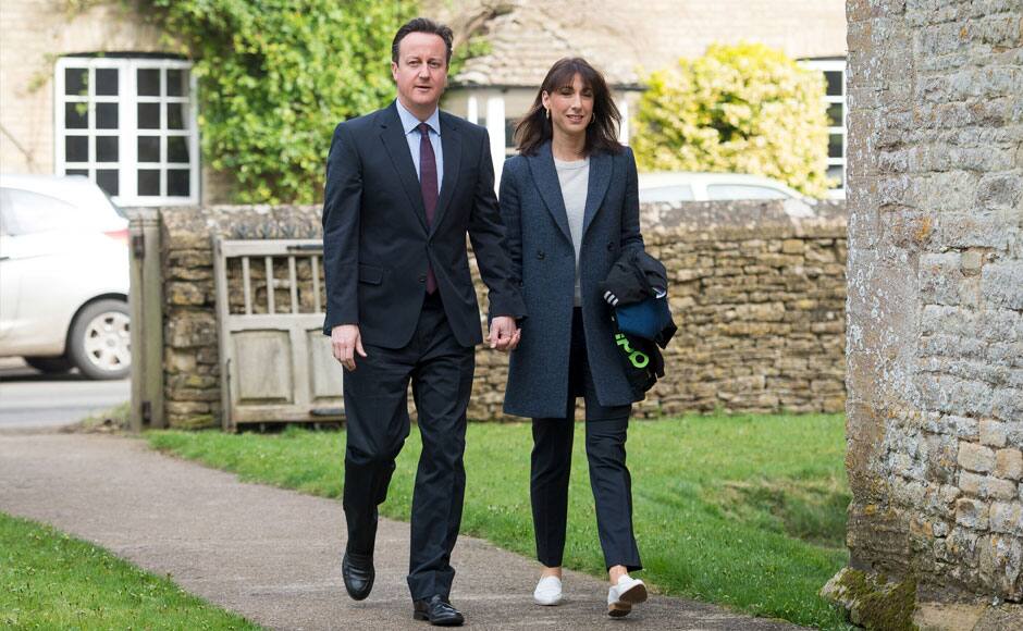 Britain's Prime Minister David Cameron and his wife Samantha arrive for an Easter Sunday service at St Nicholas church in the village of Chadlington, southern England, April 5, 2015. REUTERS