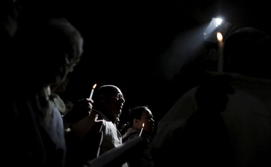 Christian worshippers hold candles during the Catholic Easter procession in the Church of the Holy Sepulchre in Jerusalem's Old City April 5, 2015. REUTERS
