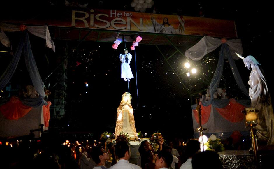 A girl portraying the role of an angel hangs from a platform during Easter Sunday celebrations in Manila April 5, 2015. REUTERS
