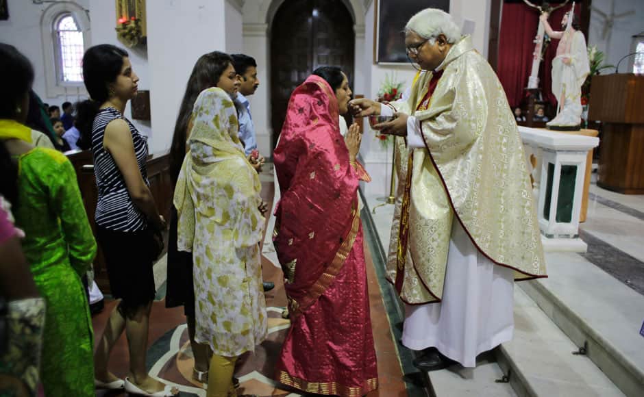 A Catholic priest offers Holy Communion to devotees on Easter Sunday at the Sacred Heart Cathedral in New Delhi, India, Sunday, April 5, 2015. Christians around the world are celebrating Easter commemorating the day when according to Christian tradition Jesus was resurrected in Jerusalem two millennia ago. AP
