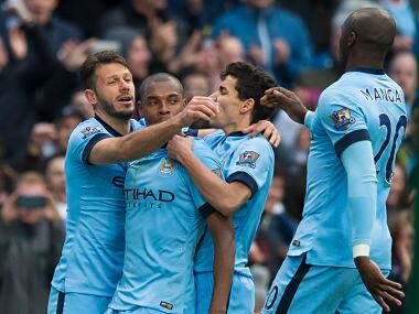 Manchester City players celebrate Fernandinho's winner. AP