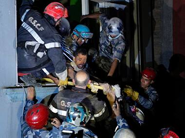 Survivor Rishi Khanal, 27, is freed by French rescuers. AP