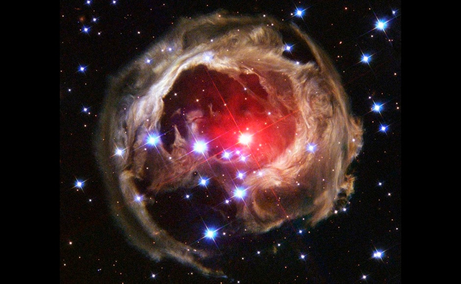 Star V838 Monocerotis's (V838 Mon) light echo, which is about six light years in diameter, is seen from the Hubble Space Telescope in this February 2004 handout photo released by NASA on December 4, 2011. Light from the flash is reflected by successively more distant rings in the ambient interstellar dust that already surrounded the star. V838 Mon lies about 20,000 light years away toward the constellation of Monoceros the unicorn. It became the brightest star in the Milky Way Galaxy in January 2002 when its outer surface greatly expanded suddenly. REUTERS/ NASA, ESA, H. E. Bond (STScI)/Handout (UNITED STATES - Tags: SCIENCE TECHNOLOGY SOCIETY TPX IMAGES OF THE DAY) FOR EDITORIAL USE ONLY. NOT FOR SALE FOR MARKETING OR ADVERTISING CAMPAIGNS. THIS IMAGE HAS BEEN SUPPLIED BY A THIRD PARTY. IT IS DISTRIBUTED, EXACTLY AS RECEIVED BY REUTERS, AS A SERVICE TO CLIENTS - RTR2UTFY