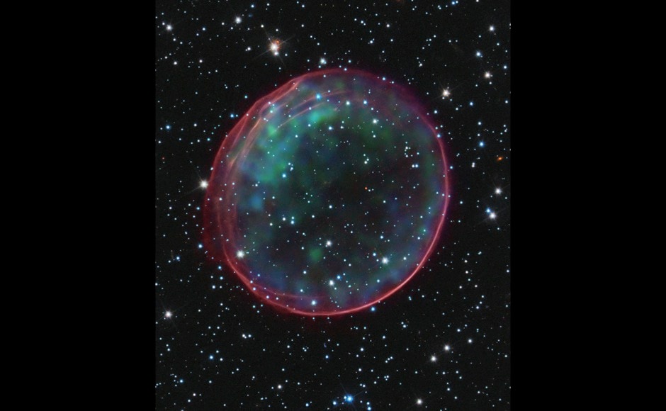 Supernova remnant 0509-67.5, located in the Large Magellanic Cloud (LMC), a small galaxy about 170,000 light-years from Earth is pictured in this NASA/ESA handout released January 11, 2012. Optical data of the supernova remnant and its accompanying star field, taken with the Hubble Space Telescope, are composited with X-ray images from the Chandra X-ray Observatory. The supernova that resulted in the creation of SNR 0509-67.5 occurred nearly 400 years ago for Earth viewers. The bubble-shaped shroud of gas is 23 light-years across and is expanding at more than 11 million miles per hour (5,000 kilometers per second). REUTERS/NASA, ESA, CXC, SAO, Hubble Heritage Team (STScI/AURA), J. Hughes (Rutgers University)/Handout (UNITED STATES - Tags: SCIENCE TECHNOLOGY TPX IMAGES OF THE DAY) FOR EDITORIAL USE ONLY. NOT FOR SALE FOR MARKETING OR ADVERTISING CAMPAIGNS. THIS IMAGE HAS BEEN SUPPLIED BY A THIRD PARTY. IT IS DISTRIBUTED, EXACTLY AS RECEIVED BY REUTERS, AS A SERVICE TO CLIENTS - RTR2W5PY