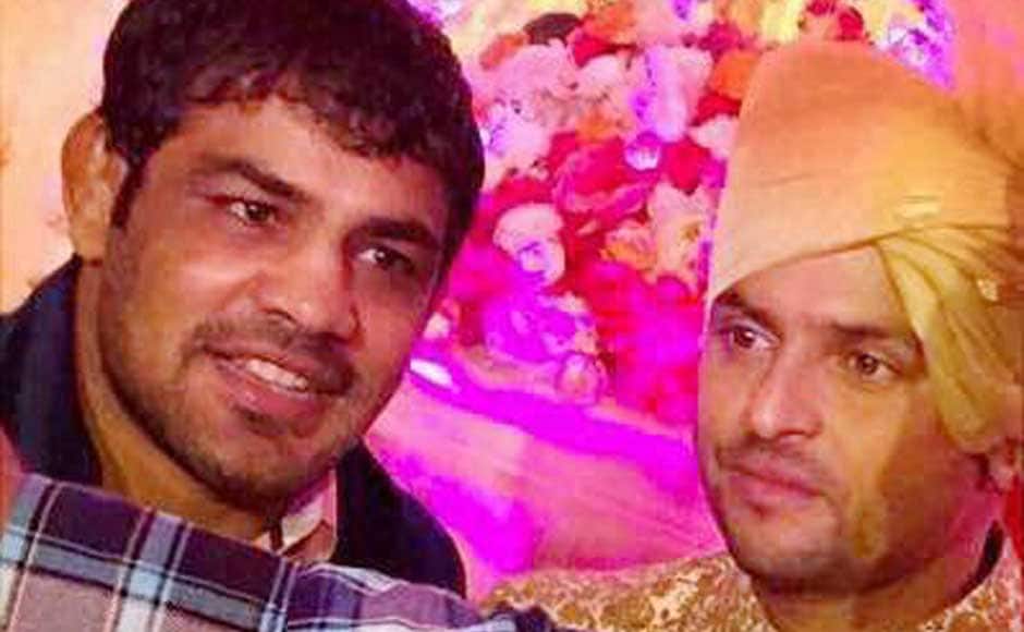 Raina with wrestler Sushil Kumar against a very colourful backdrop: PTI