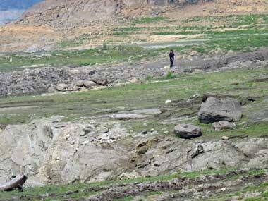 A man speaking on a phone in a dried up section of the Shihman dam in northern Taoyuan: AFP