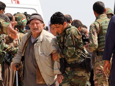 Kurdish Peshmerga forces help people from Iraq's Yazidi minority in the village of al-Humeira. AFP