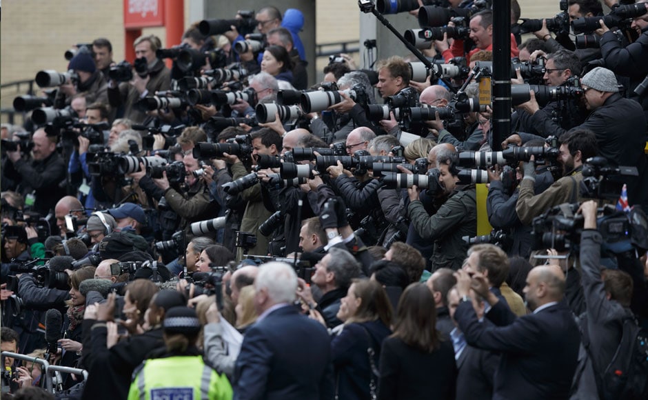 Photographers take pictures of Britain's Prince William and Kate, Duchess of Cambridge and their newborn baby princess as they pose for pictures on the steps of St. Mary's Hospital's exclusive Lindo Wing in London, Saturday, May 2, 2015. AP