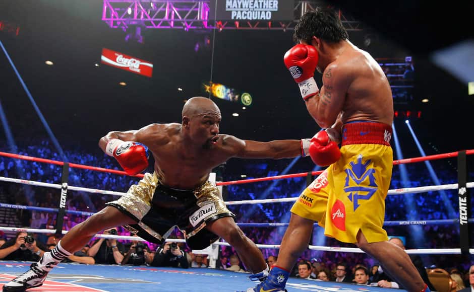 Floyd Mayweather, Jr. of the U.S. stays low against Manny Pacquiao of the Philippines in the eighth round during their welterweight WBO, WBC and WBA (Super) title fight in Las Vegas, Nevada, May 2, 2015. REUTERS
