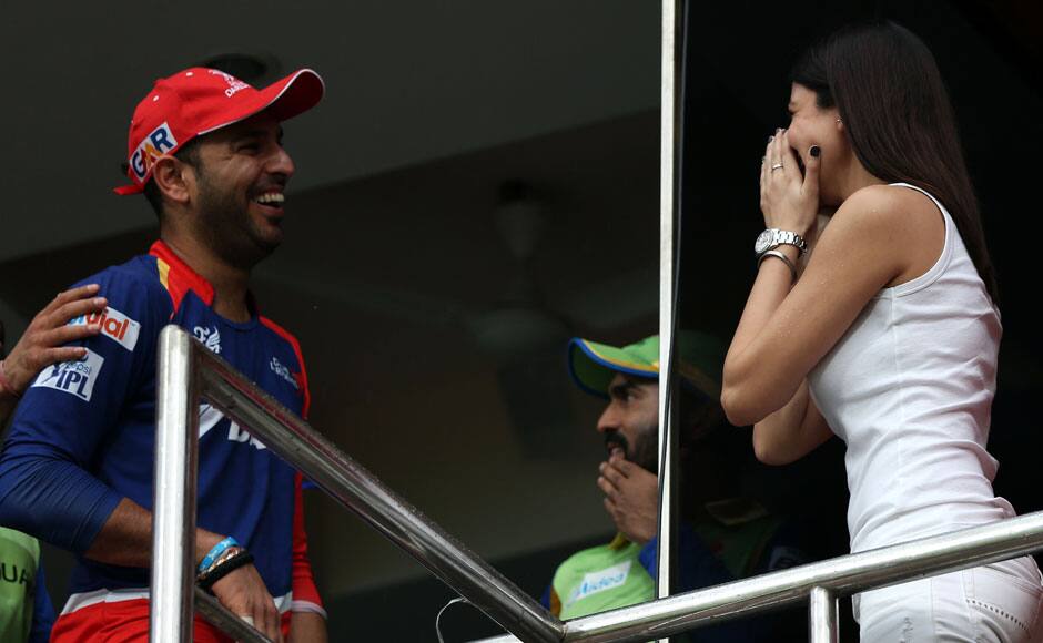 Delhi Daredevils player Yuvraj Singh has a chat with Anushka Sharma, Bollywood actor during match 55 of the Pepsi IPL 2015 (Indian Premier League) between The Royal Challengers Bangalore and The Delhi Daredevils held at the M. Chinnaswamy Stadium in Bengaluru, India on the 17th May 2015. sportzpics